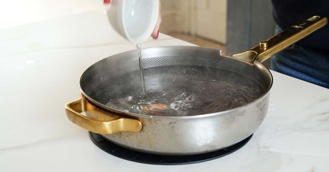 Sliding the egg into the saucepan